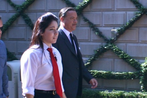 Tom Hanks, accompanied by a cast member, walks through Main Street. Tom Hanks as Walt Disney