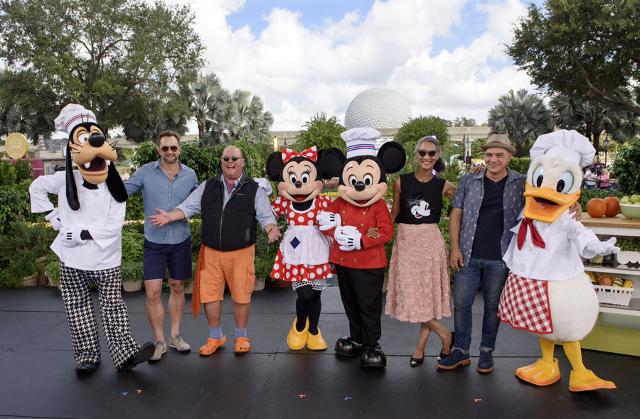 "The Chew" co-hosts (l-r) Clinton Kelly, Mario Batali, Carla Hall and Michael Symon pose with Goofy, Minnie Mouse, Mickey Mouse and Donald Duck during a week of filming at Walt Disney World Resort highlighting the Epcot International Food & Wine Festival.