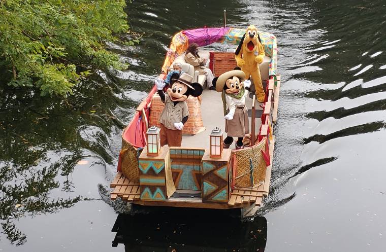 Mickey Mouse, Minnie Mouse, and Pluto on a boat at Disney's Animal Kingdom