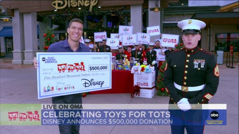 GMA's Gio Benitez presented a check for $500,000 from Disney to Toys to Tots, which was accepted by Marine Staff Sergeant Ash Jacques