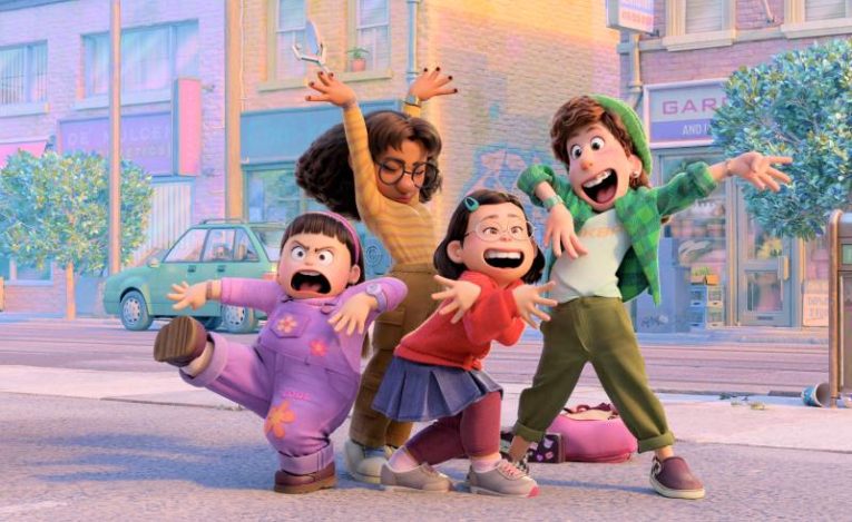 Four characters from Pixar's Turning Red posing with silly faces on a street