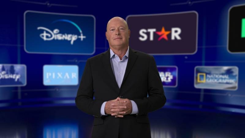 Bob Chapek in front of wall of Disney streaming services